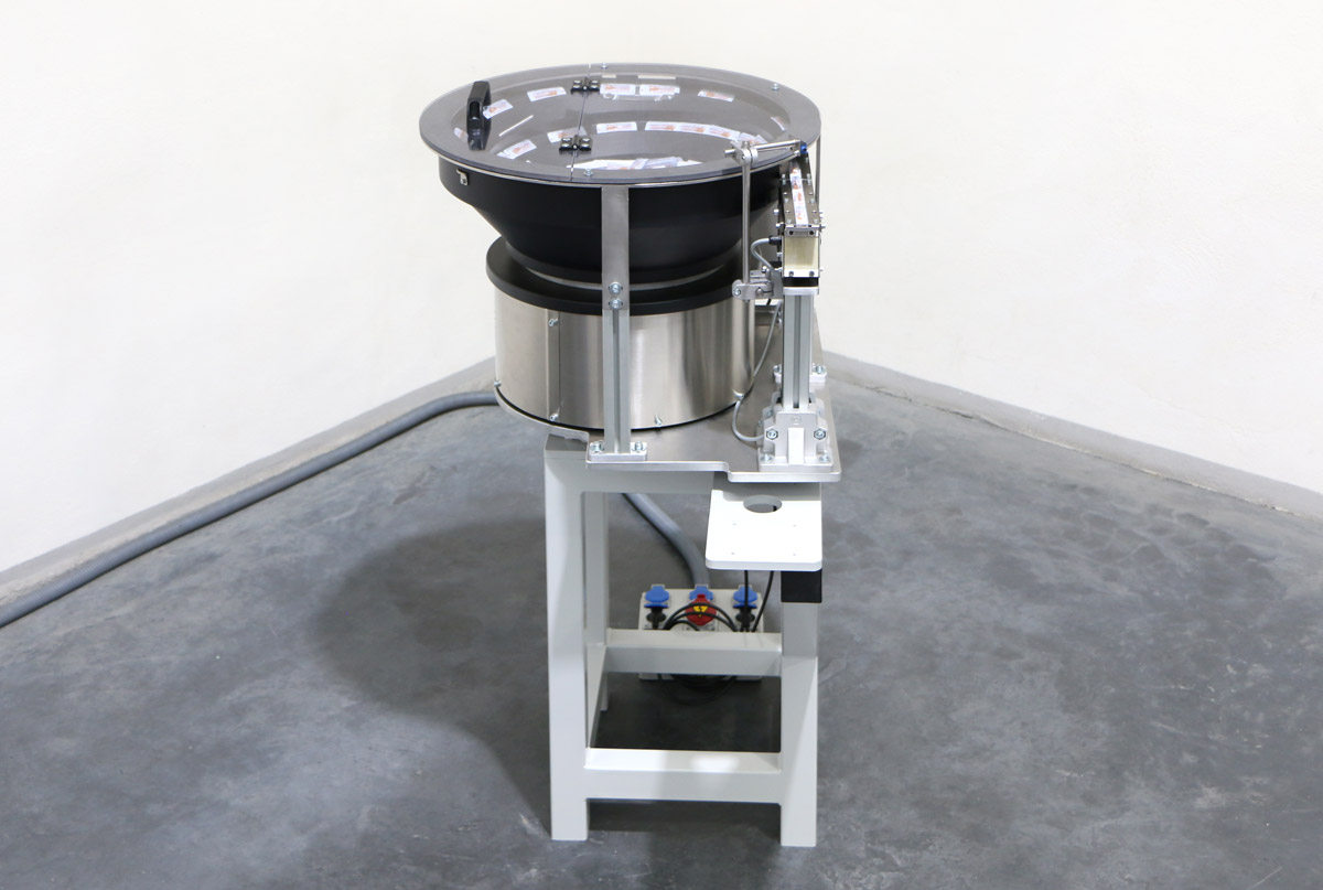 Alimentador industrial con tolva vibratoria para posicionar canulas de la industria farmaceutica vista frontal