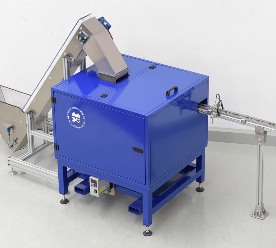 Sistema vibratorio con cinta elevadora para argollas