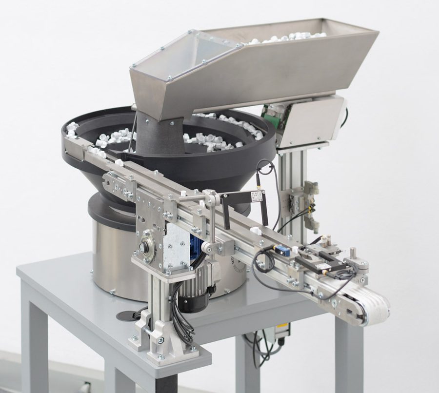 Posicionador dispensador vibratorio para tapones de nevera